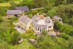 an aerial view of a large house in the forest at Writing Shed Wales in Login