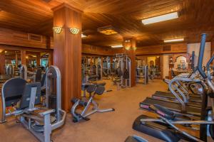 a gym with a lot of treadmills and machines at The Springs Resort & Spa at Arenal in Fortuna