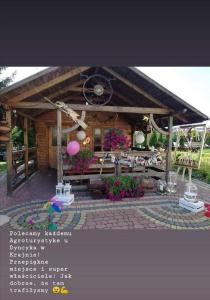 a picture of a wooden cabin with a patio at Noclegi U Dyncyka in Krajno Pierwsze