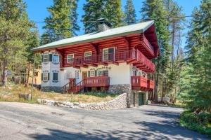 a log home with red balconies on a street at Vienna Villa - 3 Bed 3 Bath Vacation home in Shaver Lake in Shaver Lake