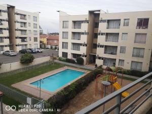 a swimming pool in front of a apartment complex at Relajado y central in Rancagua