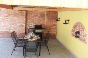 a patio with a table and chairs and a brick wall at Apartmány Hradiště in Znojmo
