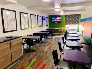 
a restaurant with tables, chairs, and tables in it at La Quinta Inn by Wyndham Orlando International Drive North in Orlando
