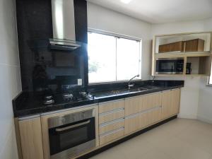 cocina con fregadero y ventana en 1034 - Apartamento para locação em Bombinhas, en Bombinhas