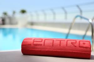 a red object with the word sits next to a pool at Centro Capital Centre By Rotana in Abu Dhabi