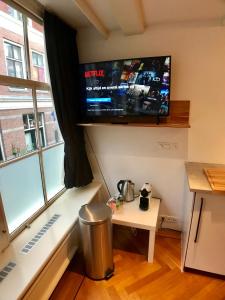 a small room with a table and a large window at Heerengracht Penthouse Apartment in Amsterdam