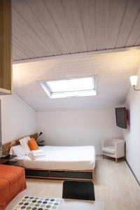 a bedroom with a bed and a skylight at Maria Salome in Burgos