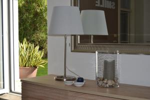 a lamp sitting on a table next to a window at Casa Smile in Riva del Garda