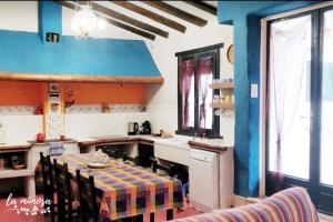 a kitchen with a table and chairs in a room at La mimosa in Carcastillo