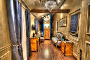 a train car hallway with chairs and a table at The Originals Boutique, Hôtel Aultia, Ault in Ault