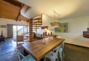 a living room with a wooden table and chairs at Kamaole Sands 4-410 in Wailea