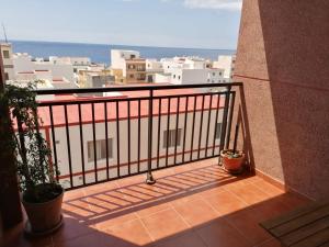 a balcony with a view of a city at Ecorestinga in La Restinga