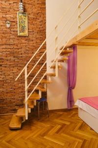a staircase in a room with a bedroom and a bed at Comfortable Flat in Central Tbilisi in Tbilisi City