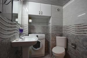 a bathroom with a sink and a toilet at Comfortable Flat in Central Tbilisi in Tbilisi City