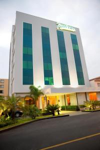 a large white building with a sign on it at Radisson Hotel San Isidro in Lima