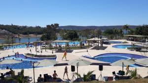 a group of people at a resort with two pools at Ilhas do Lago EcoResort in Caldas Novas