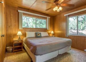 a bedroom with a bed and a ceiling fan at Bear's Den in Idyllwild +16 photos