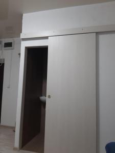 a white wall with a door in a room at Жилье отдельное in Odesa