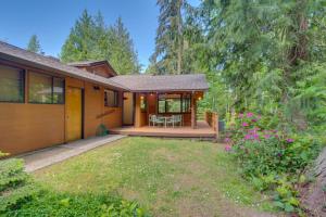 a house with a patio and a yard at Sleeping Raven Woodland Retreat in Port Angeles