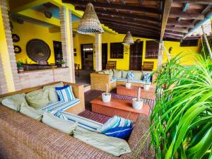 a patio with couches and chairs on a house at Pousada Canto do Rio in Prado