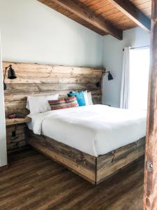 sypialnia z dużym łóżkiem z drewnianym zagłówkiem w obiekcie Lone Point Cellars w mieście Brewster