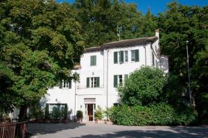 a large white house with a large window at Sette Querce in San Casciano dei Bagni