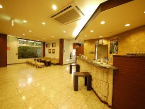 a restaurant with a bar and tables and chairs at Hotel Route-Inn Court Ina in Ina