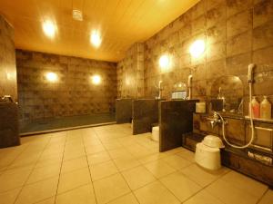 a large bathroom with a shower and a sink at Hotel Route-Inn Ina Inter in Minamiminowa