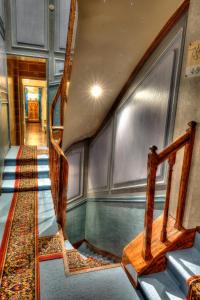 a set of stairs in a room with a hallway at The Originals Boutique, Hôtel Aultia, Ault in Ault