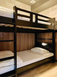 a bunk bed room with two bunk beds in it at Hotel Capsule Inn Shizuoka in Shizuoka