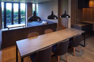 a dining room with a table and a bed at Hakone Yutowa in Hakone