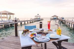een tafel met eten aan de oceaan bij Kept Bangsaray Hotel Pattaya in Bang Sare