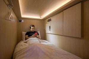Uma cama ou camas num quarto em CUBE Boutique Capsule Hotel at Kampong Glam