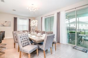 a dining room with a table and chairs at 1719Cvt Orlando Newest Resort Community Home Villa in Orlando