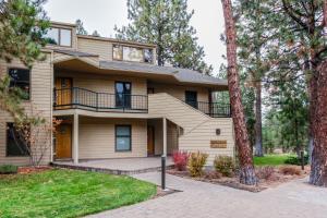 a large house with a balcony and trees at Mt Bachelor Village Ski House # 262 in Bend