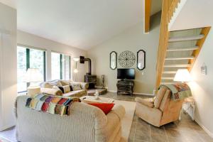 a living room with two couches and a staircase at Aspen Village Condo #H-39 in McCall