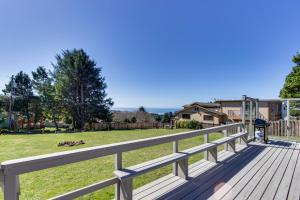 a wooden deck with a view of a yard at Crystal Rose Home and Cottage in Lincoln City