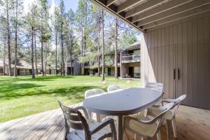 a patio with a table and chairs on a deck at Meadow House 15 | Discover Sunriver in Sunriver