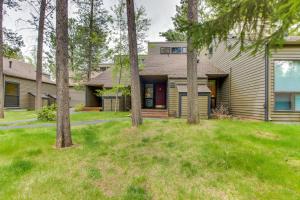 a house with trees in front of a yard at Mt View 33 | Discover Sunriver in Sunriver