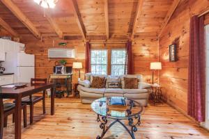 a living room with a couch and a table at Angler's Haven in Sautee Nacoochee