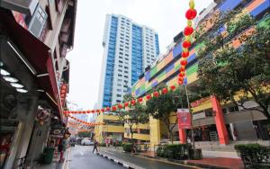 una calle de la ciudad con una cadena de luces rojas y amarillas en CUBE Boutique Capsule Hotel at Chinatown, en Singapur