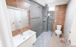 a bathroom with a shower and a toilet and a sink at Color Ville Hotel SHA Certified in Sakon Nakhon