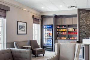 a drink station in a restaurant with a refrigerator at Chateau Moncton Trademark Collection by Wyndham in Moncton