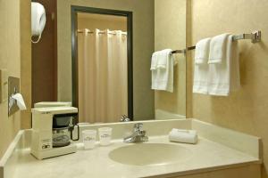 a bathroom with a sink with a coffee maker at Baymont by Wyndham Tuscola in Tuscola