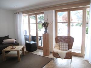 a living room with a couch and a chair at Ferienlandhaus Alpinum in Lenggries