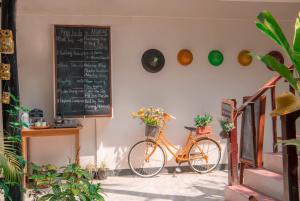a bike parked next to a wall with a chalkboard at The Villager lodge in Ngapali