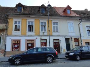 a black car parked in front of a building at Alexandra Studios in Sibiu