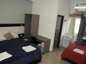 Ένα ή περισσότερα κρεβάτια σε δωμάτιο στο Hotel Puesta del Sol by Nobile