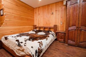 a bedroom with a bed in a wooden room at Aurooms in Novokuznetsk