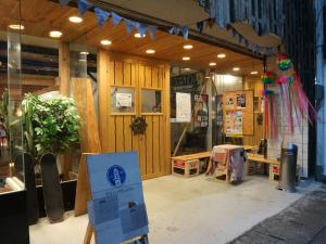 a store front with a sign in front of it at Guest House Minato in Miyako